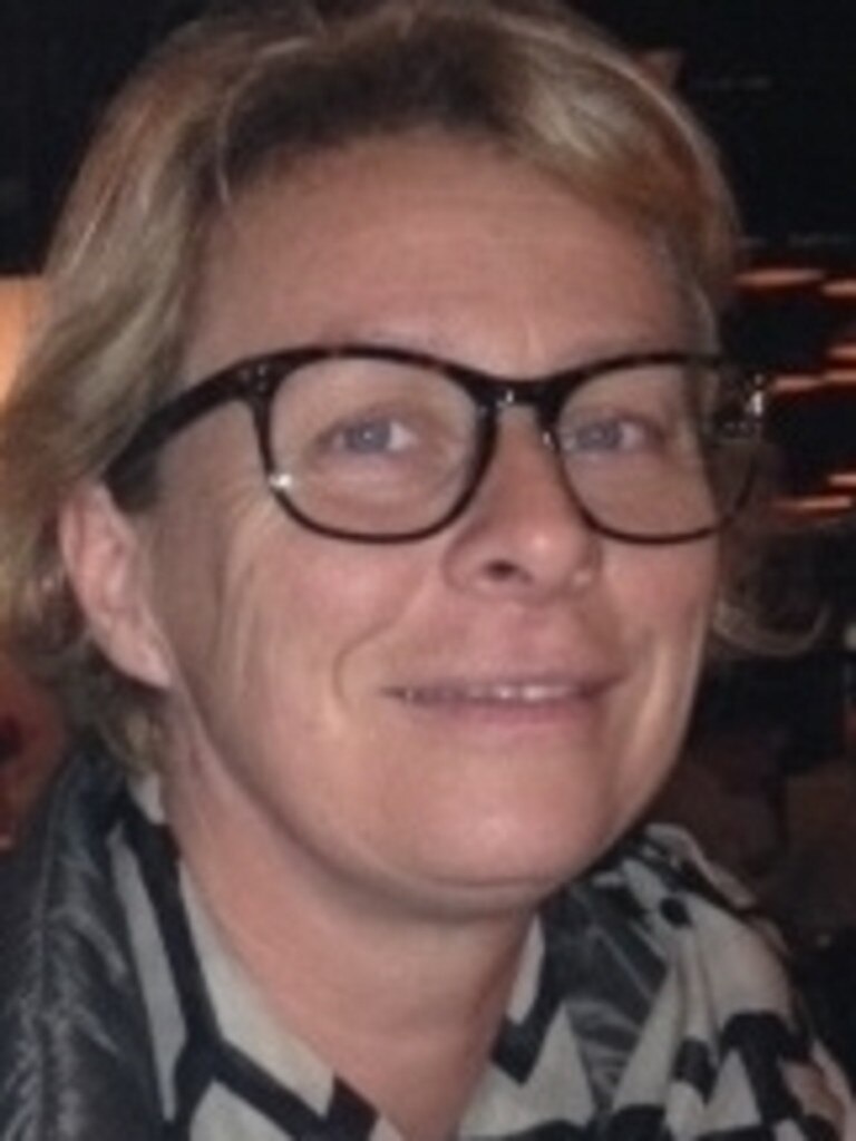 Dr Heike Neumeister-Kemp wearing black glasses and a white scafrf