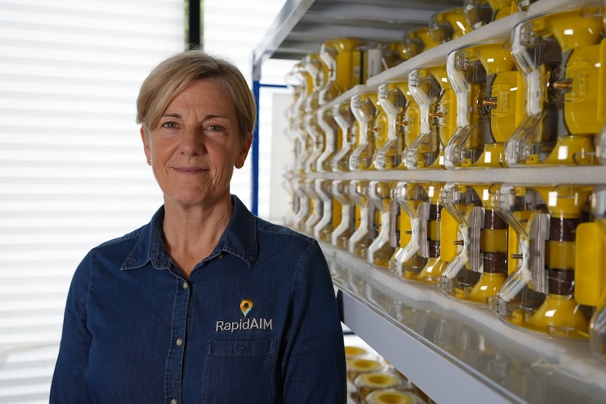 Photo of woman smiling in a science laboratory.