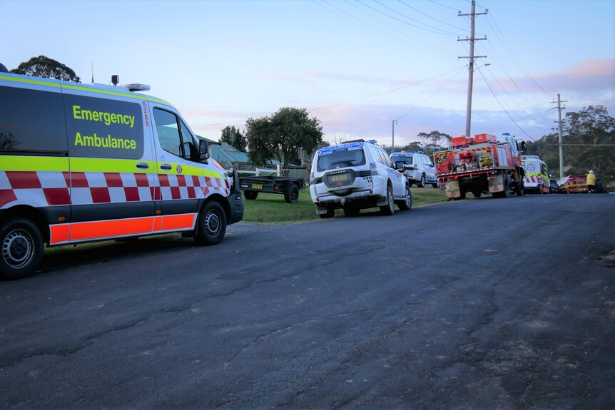 a row of emergency service vehicles parked on a street