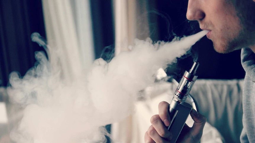 A man uses an e-cigarette