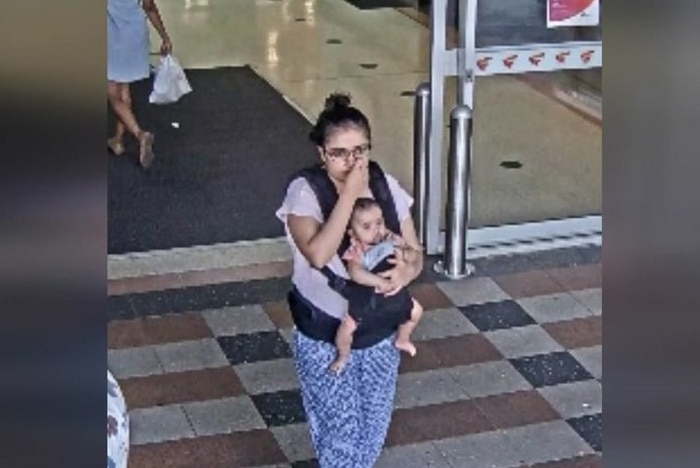 A woman and child seen leaving Buranda Shopping Centre.