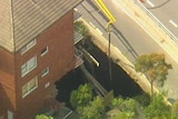 A hole 10-metres wide by 10-metres deep has caused major erosion around the foundations of the unit complex at Lane Cove.
