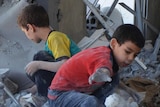 Syrian children search bomb site in Damascus