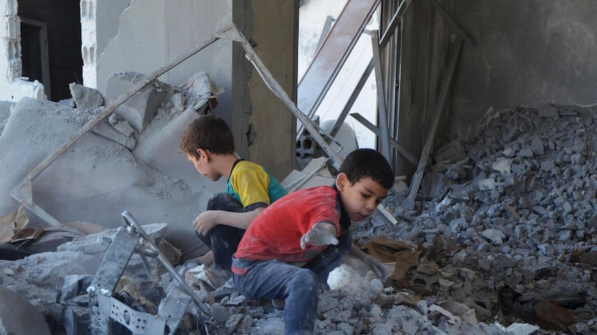 Syrian children search bomb site in Damascus