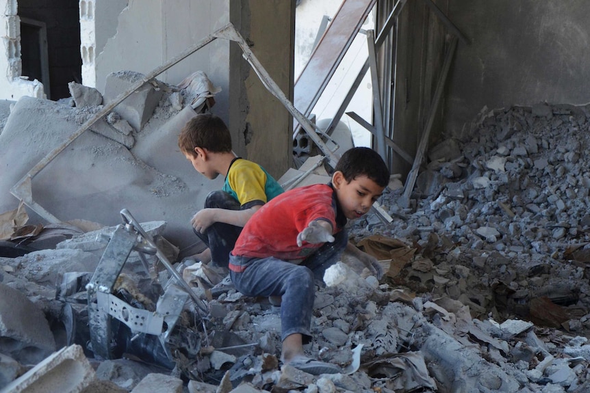 Syrian children search bomb site in Damascus