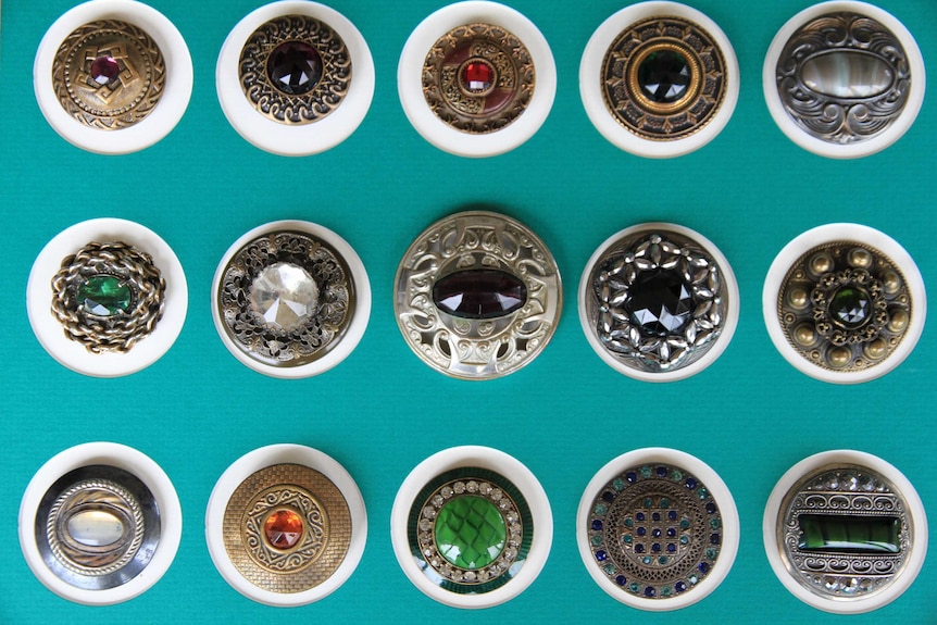 A collection of buttons sitting on white circles on a green background.