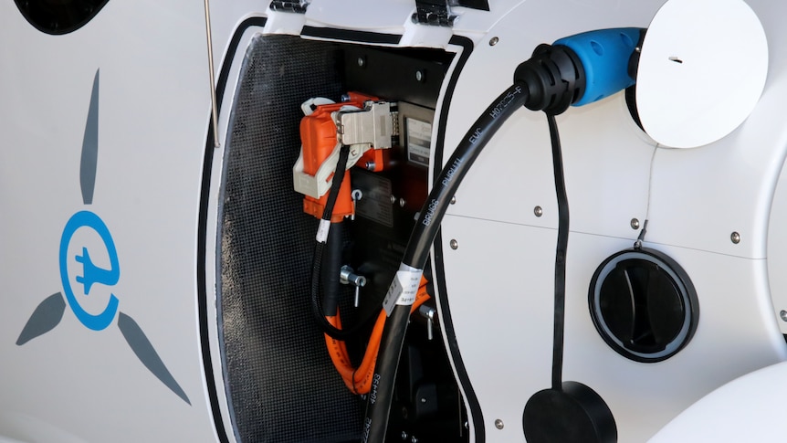 A close-up of the charging dock of an electric plane