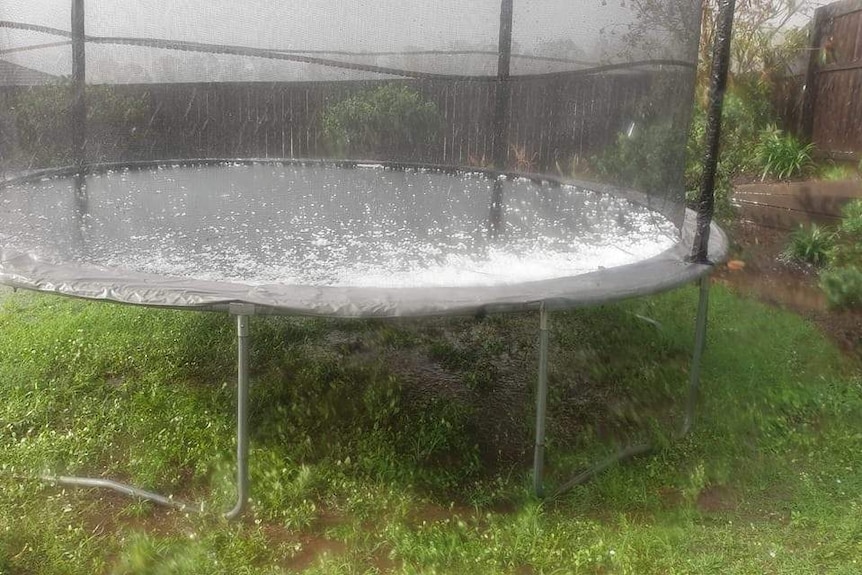 Hail blankets a trampoline in a Beaudesert backyard