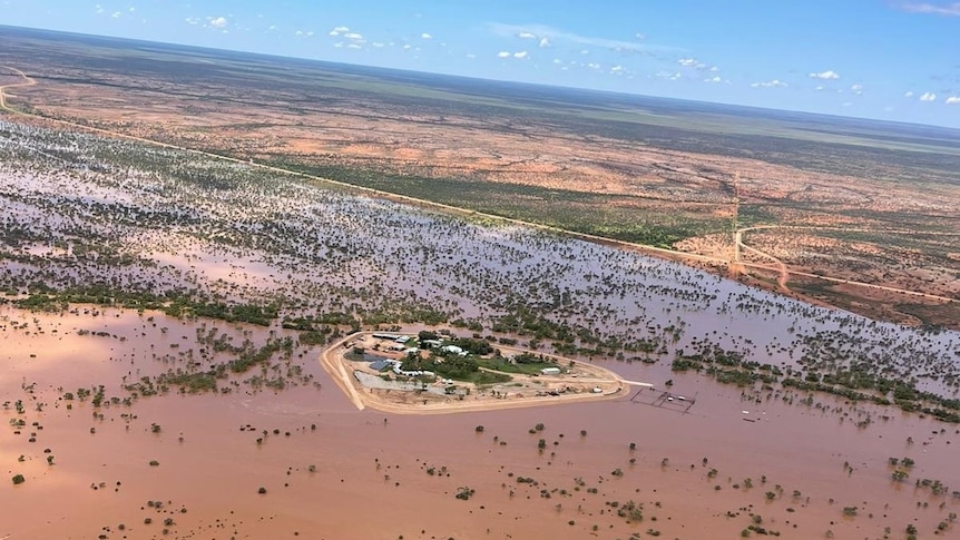 An aerial view of an outback station surrounded by floodwater