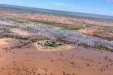 An aerial view of an outback station surrounded by floodwater