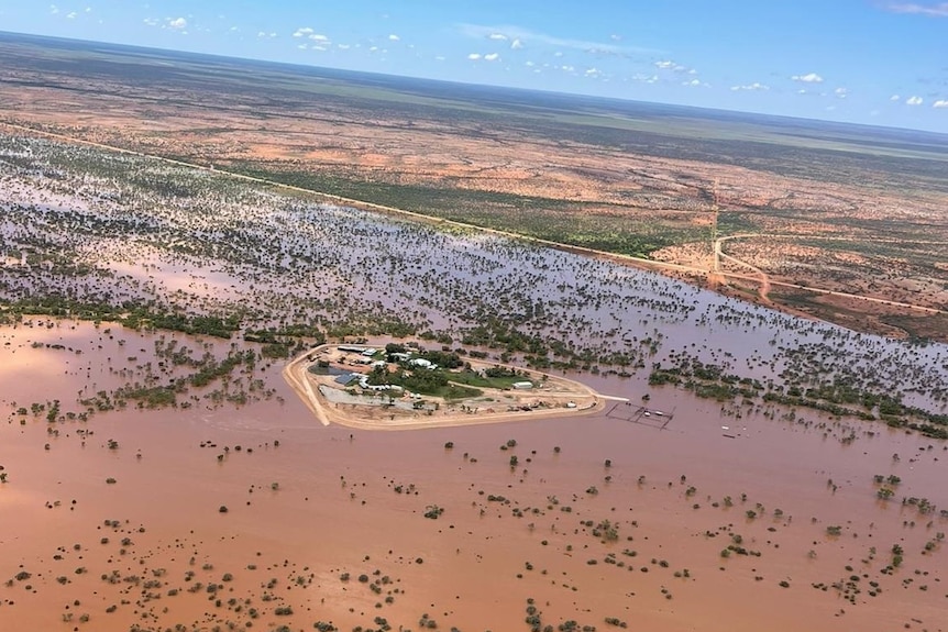 An aerial view of an outback station surrounded by floodwater