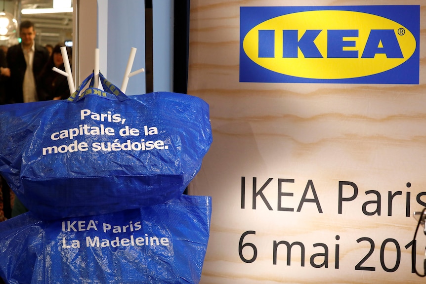 IKEA logo and bags with French writing hanging outside the IKEA store in Paris.