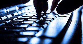 Close-up of fingers on a keyboard.