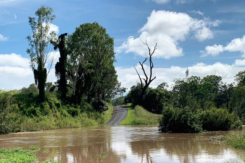 A creek cuts a road at Kilkivan.