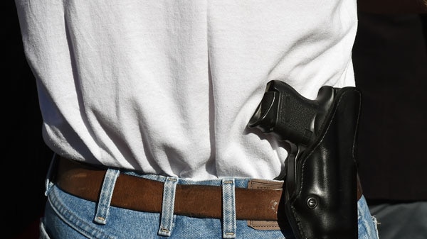 A person wearing a holstered gun