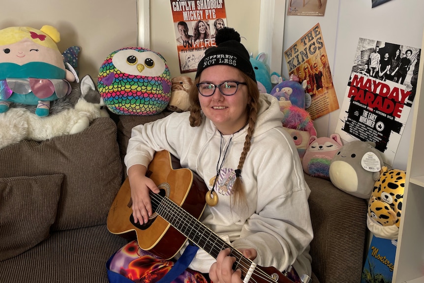 Renee Williams at home with a guitar after recovering from sepsis. Ryan's Rule needed to be called during her hospital stay.