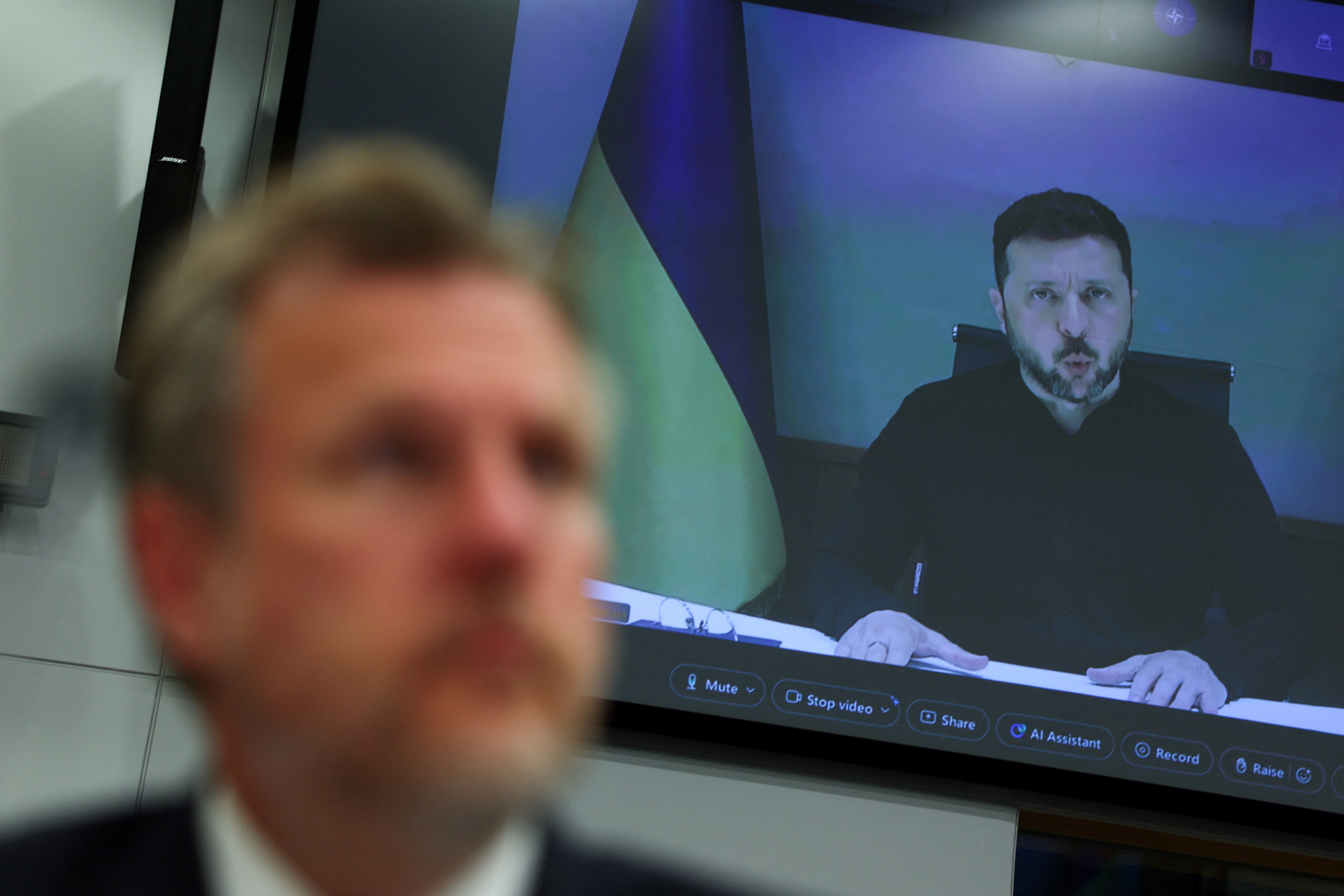 Volodymyr Zelenskyy speaks on a TV screen