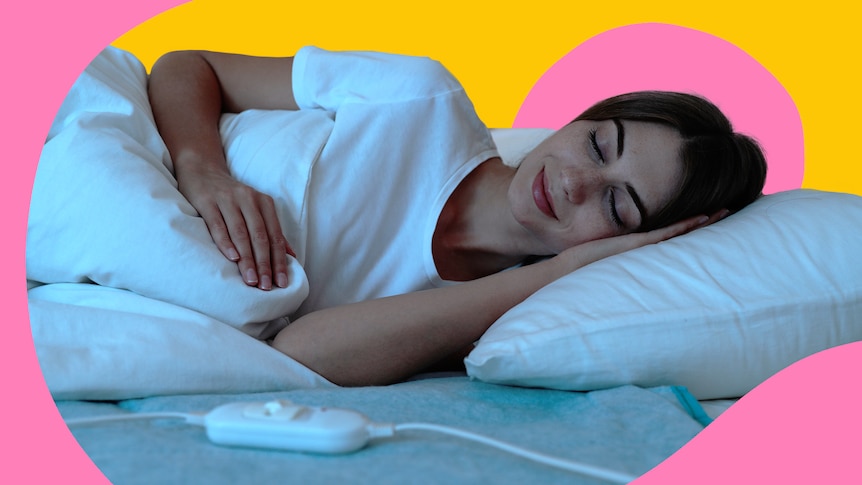 woman lying on bed with a electric blanket remote in front of her