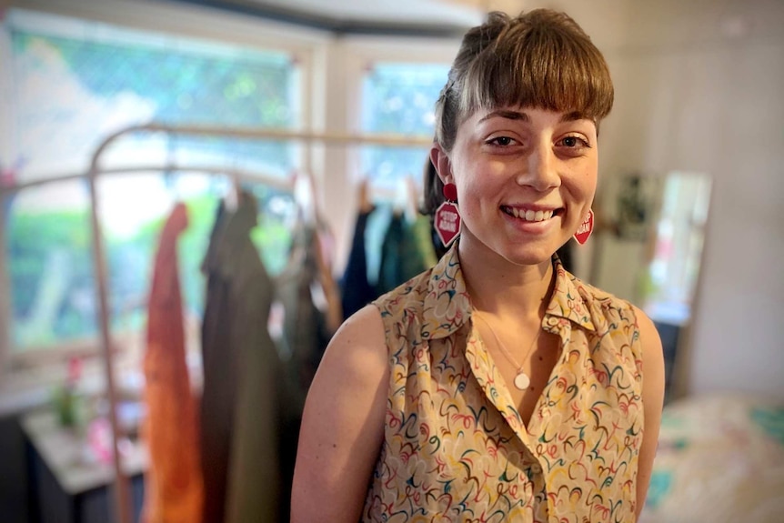 a young girl in a room smiling at the camera