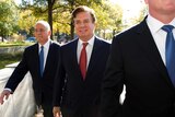 Paul Manafort (C) accompanied by his lawyers, arrives at federal court.