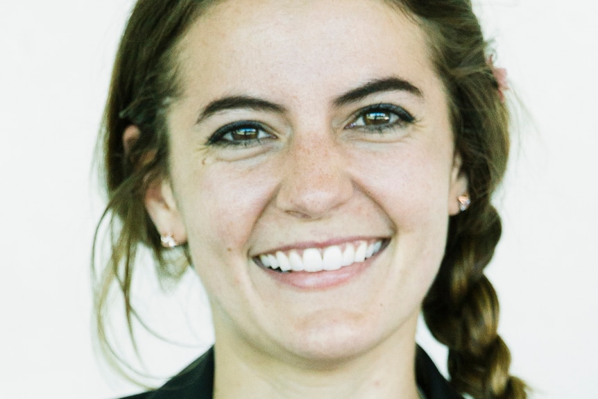 A cloes up headshot of a woman smiling. 