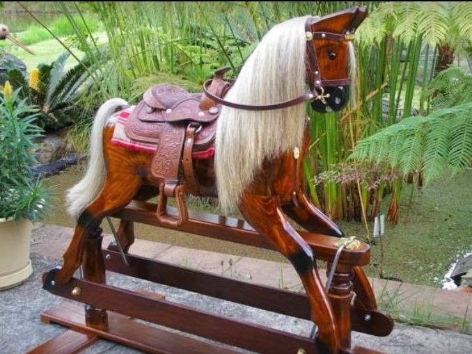 A beautiful rocking horse in a garden setting.