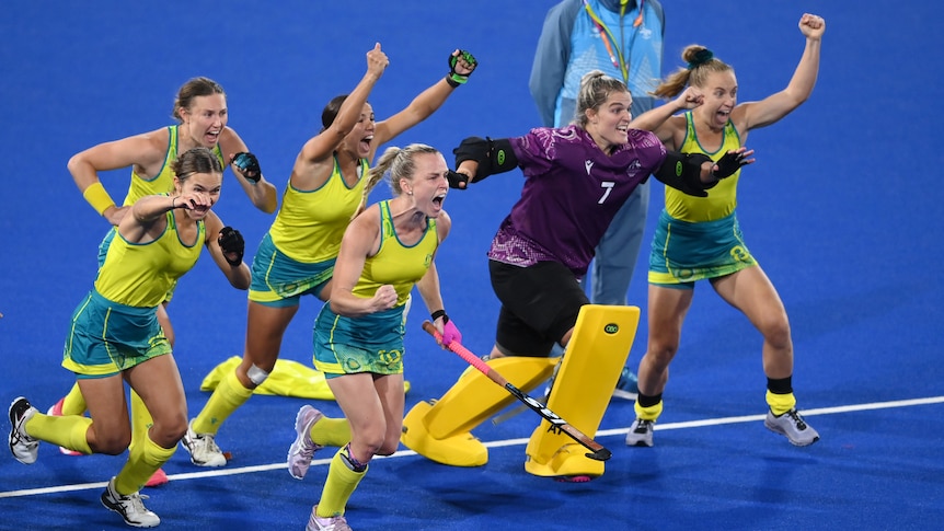 Hockeyroos players run and shout with joy after winning the Commonwealth Games semi-final shootout.