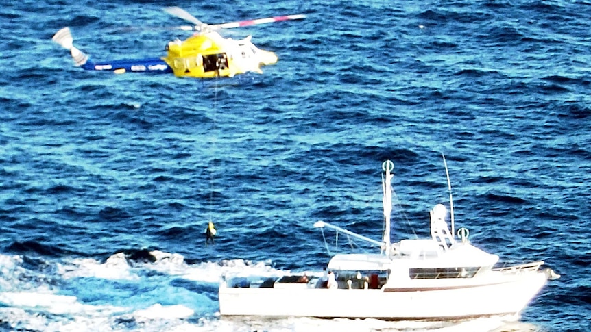 A fisherman is winched from a boat after he was seriously injured by swordfish bill.