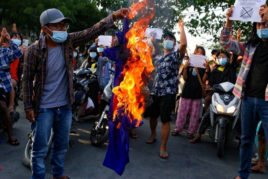 Protesters against Myanmar's junta burn the flag of the Association of Southeast Asian Nations