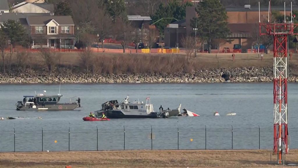 Investigators at the crash site of the DC helicopter and plane ...
