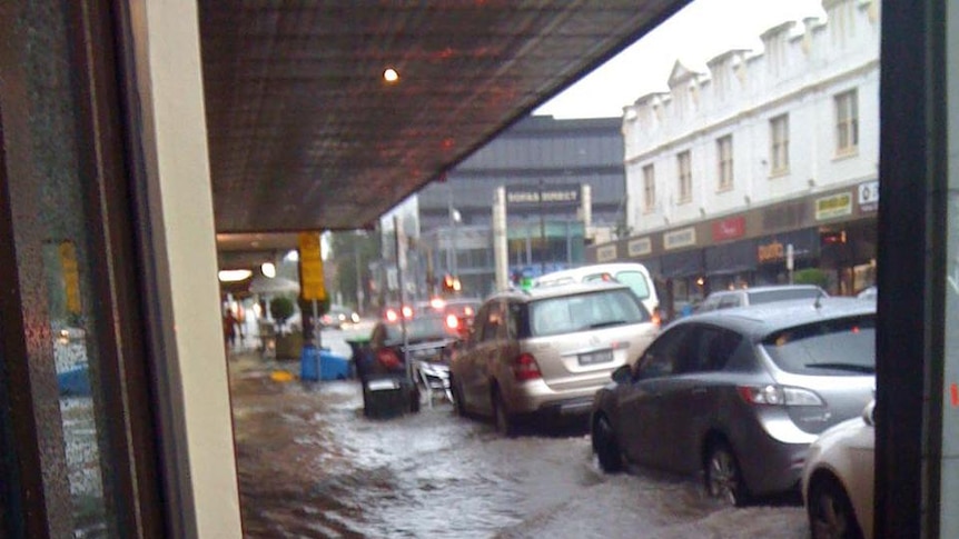 Flash Flooding surrounds cars at Camberwell Junction.