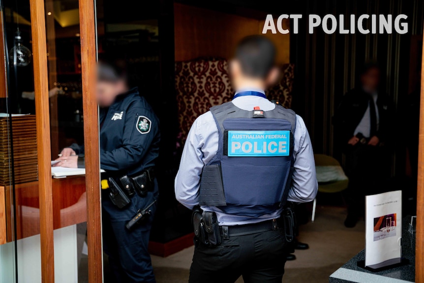 Two anonymous policemen walk into a Canberra restaurant