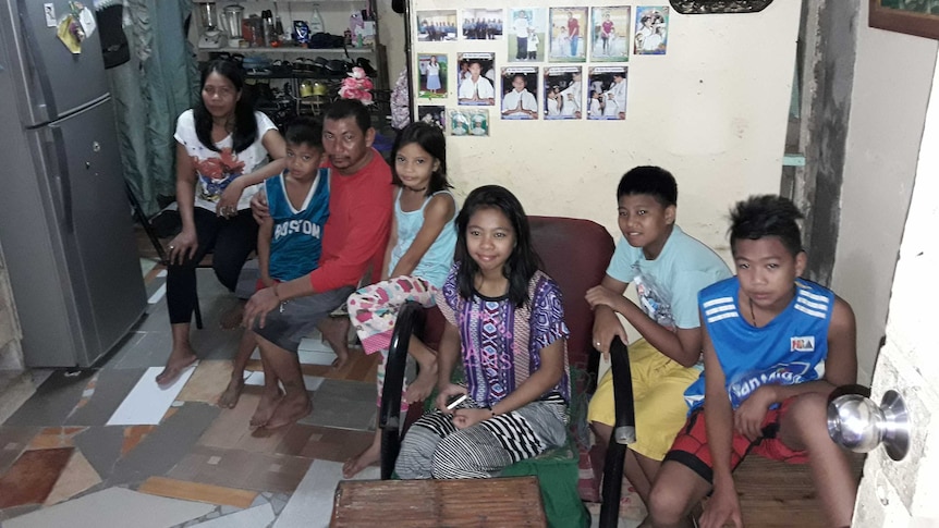 Richard, his wife Mercy, and their five children at their home at the Payatas Dumpsite.