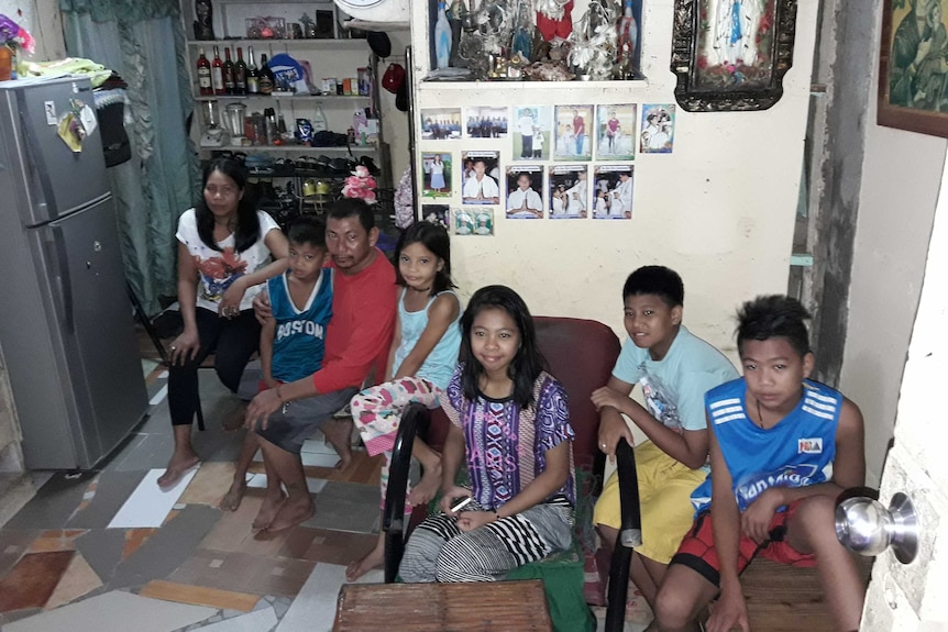 Richard, his wife Mercy, and their five children at their home at the Payatas Dumpsite.