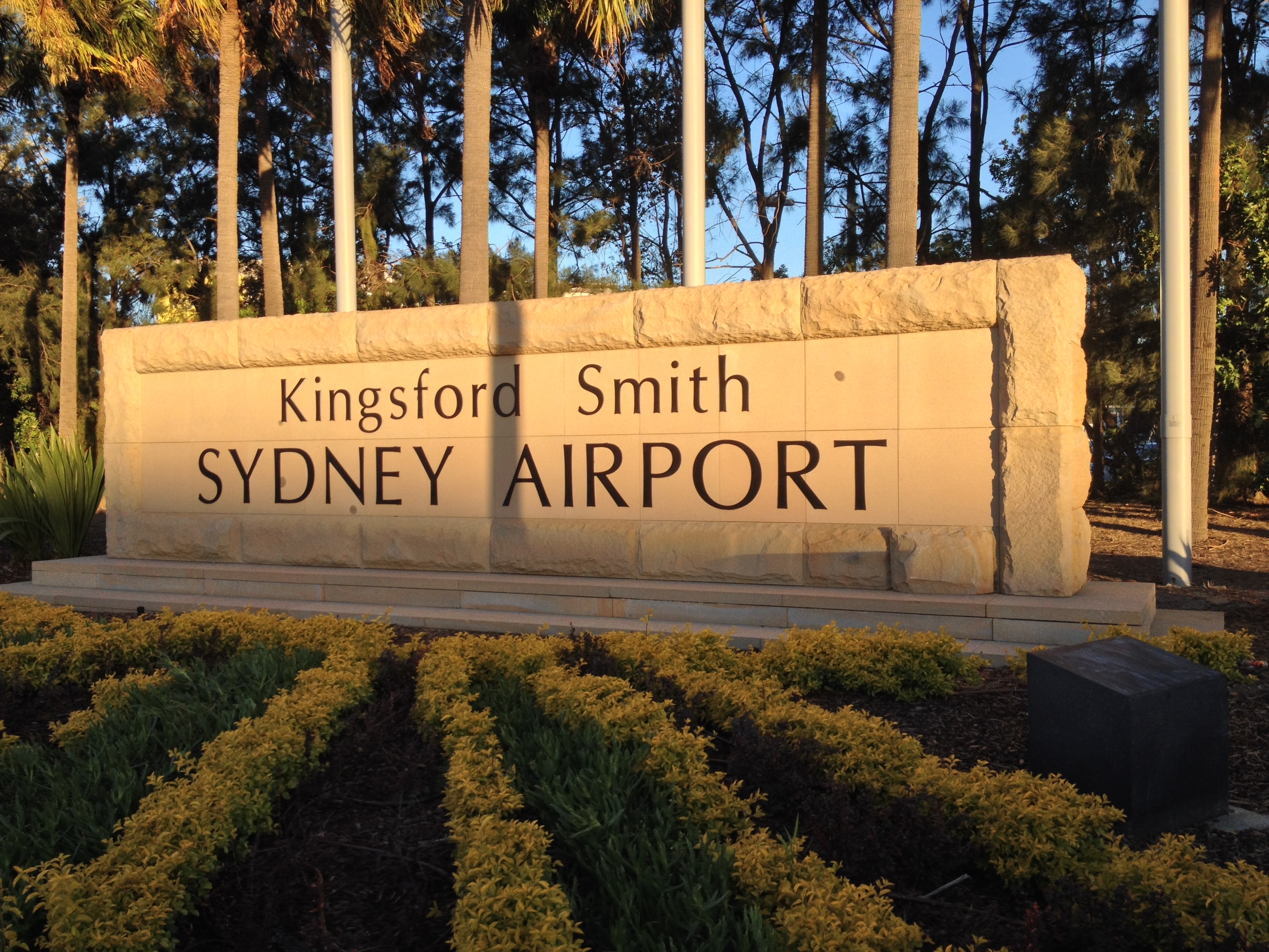 A sign that reads "Kingsford Smith SYDNEY AIRPORT" 