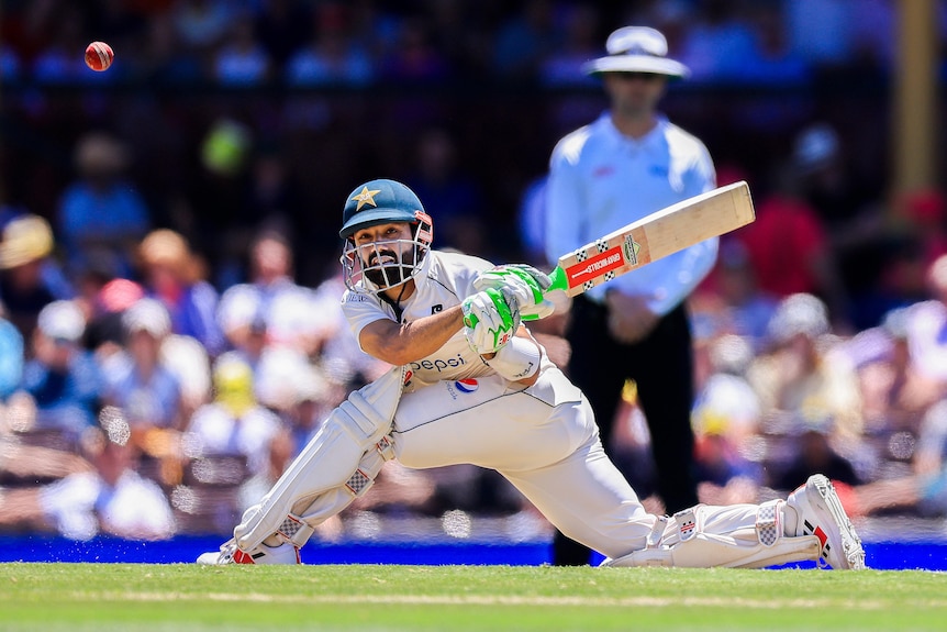 Pakistan batter Muhammad Rizwan plays a sweep shot during a Test against Australia.
