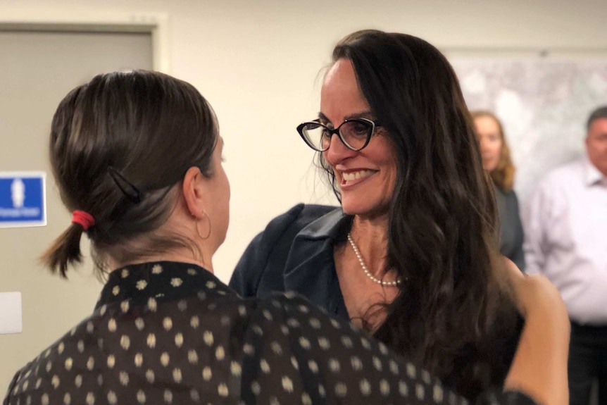 Logan City Council CEO Sharon Kelsey being hugged by a supporter after being sacked by majority councillors on February 7, 2018.