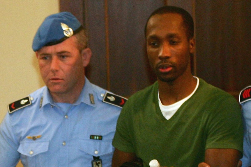 Rudy Guede is escorted by police.