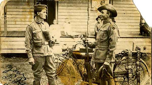 Percy Pepper (right), in his army uniform, with a fellow returned soldier (wearing a souvenired German uniform), early 1920s This photograph was taken at the Pepper home at Koo-Wee-Rup. Family members can be seen in the background. (image courtesy of: The Watkins family)