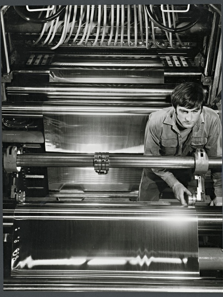 Worker operating the cutting apparatus on the aluminium sheet slitting line