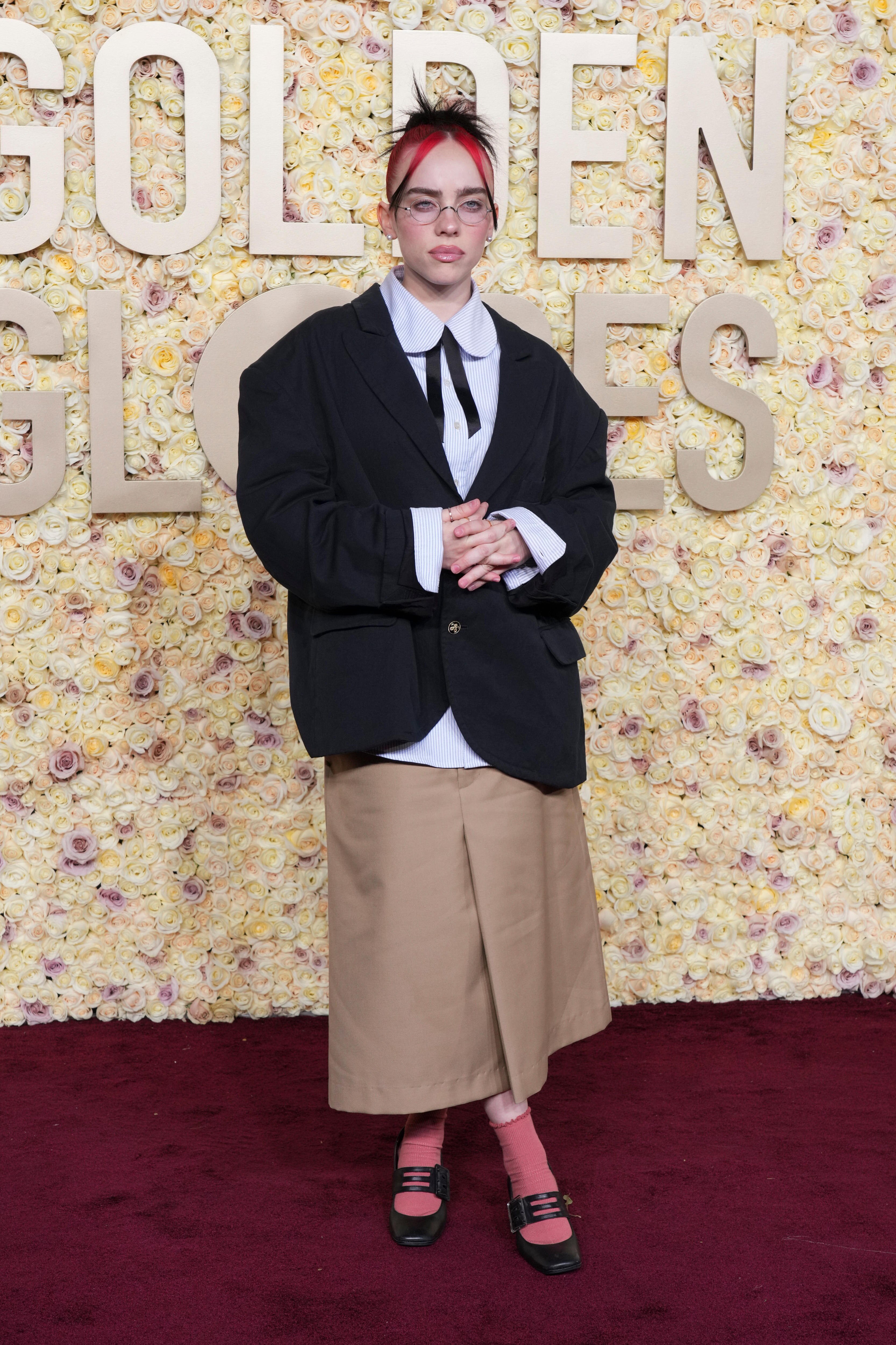 Artist Billie Eilish wore an oversized top and long baggy skirt to the golden globes red carpet