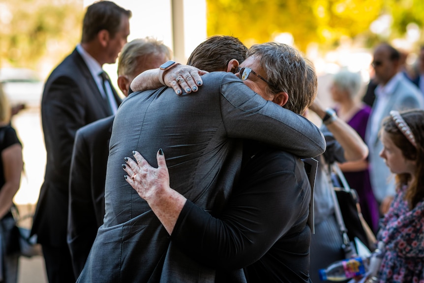 Adam Gilchrist hugs Roslyn Marsh