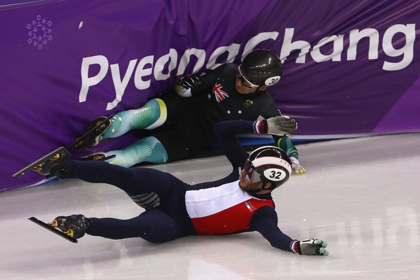 Andy Jung (top) crashes into a barrier with Thibaut Fauconnet sliding in front of him