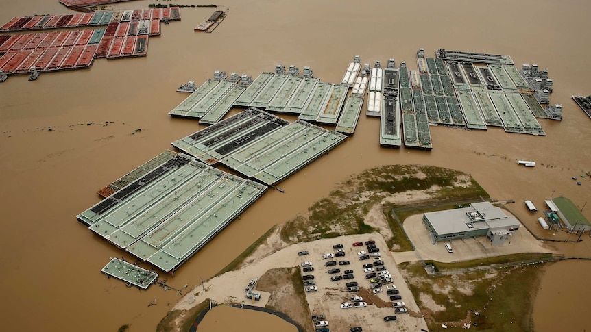 Flood waters are seen spreading through an industrial area in Texas.