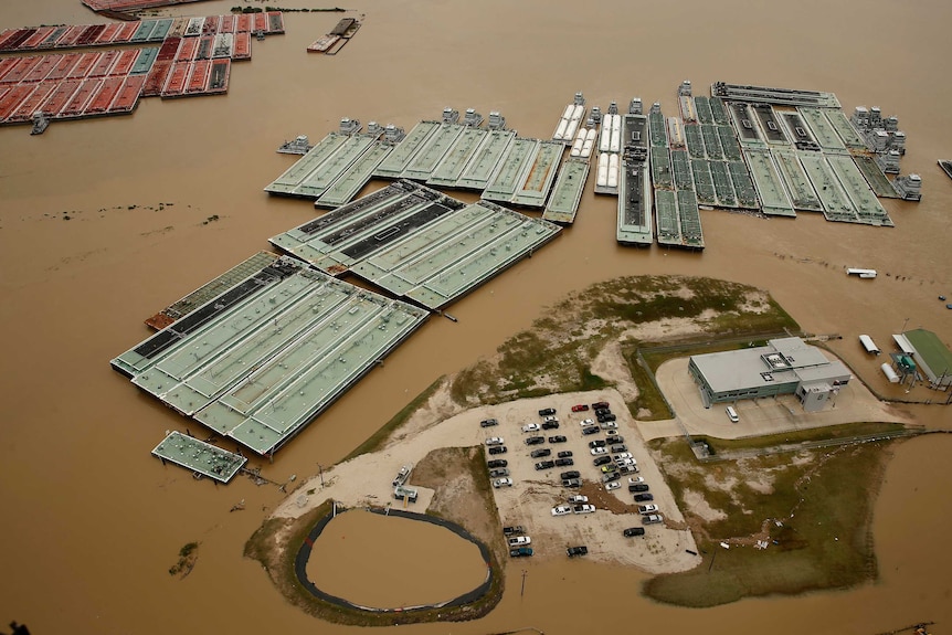 Flood waters are seen spreading through an industrial area in Texas.