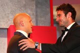 Gary Ablett of the Suns is congratulated by last year's winner Jobe Watson of the Bombers after winning the 2013 Brownlow Medal