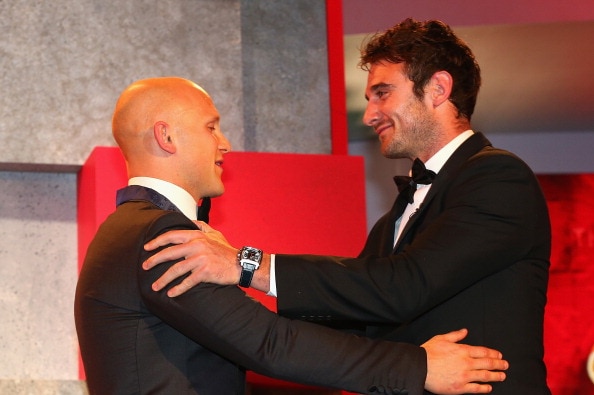 Gary Ablett of the Suns is congratulated by last year's winner Jobe Watson of the Bombers after winning the 2013 Brownlow Medal