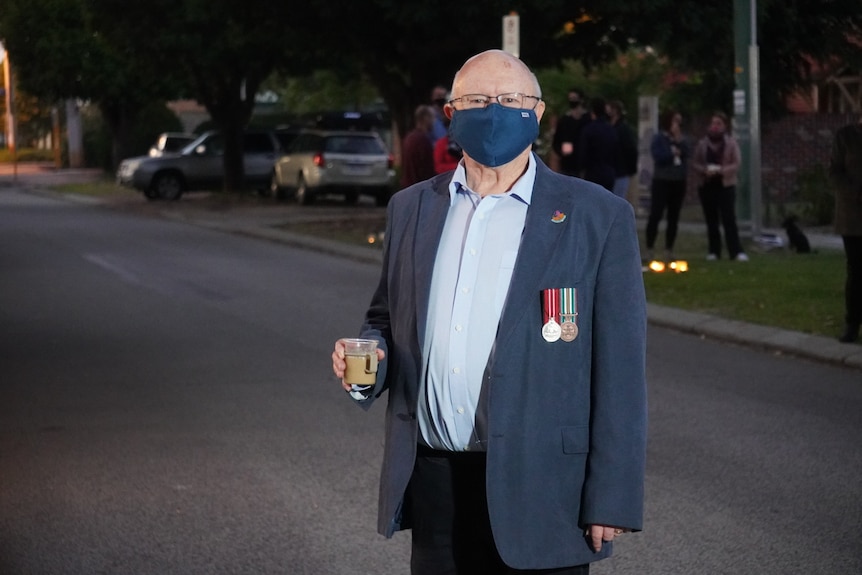 Graeme Cucel holds a rum coffee as he stands on a Perth street.