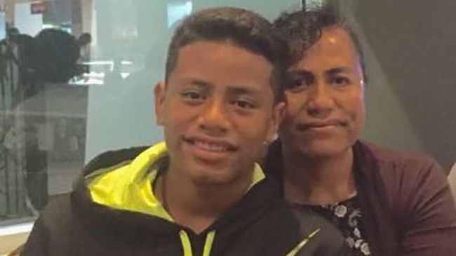 A teenage boy (L) with his mother