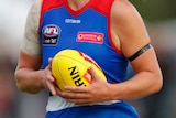 A file photo of a Western Bulldogs AFLW player holding a football.
